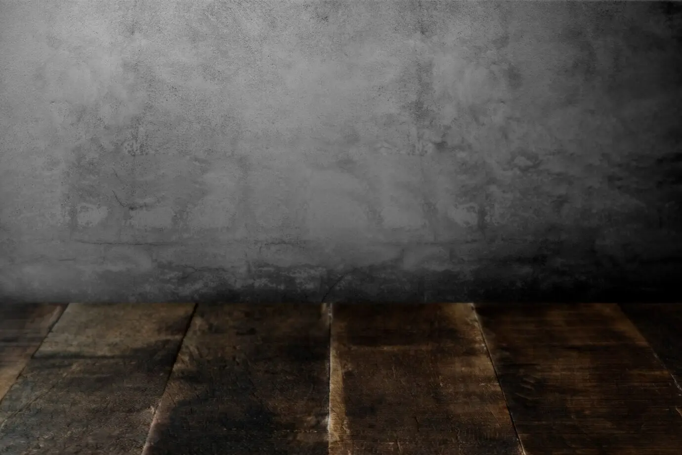 Weathered wooden boards beside a concrete wall.